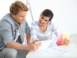 Couple in new home choosing wall paint colours